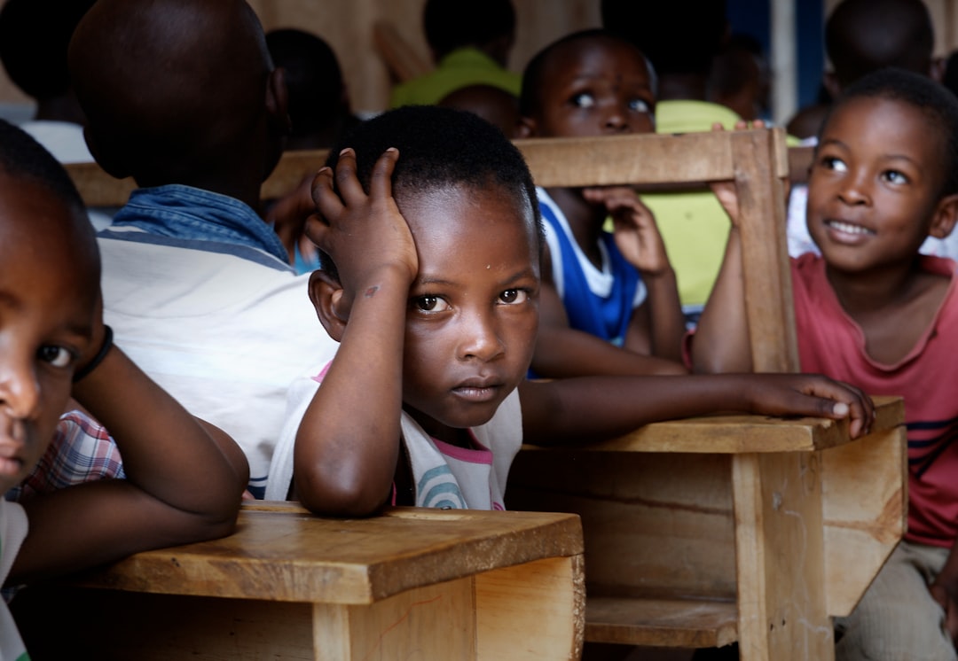 Ugandan student finding it too hard to study.  These African children are the sweetest kids on earth.  This was taken at a GODLOVESKIDS.com location in Nakasaki (nuh kasa kee) school district.  GodLovesKids.com is helping hundreds of children and orphans throughout the world.